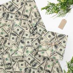 a pile of money sitting on top of a table next to a pair of glasses