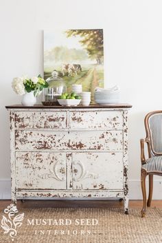 an old dresser is decorated with flowers and plates