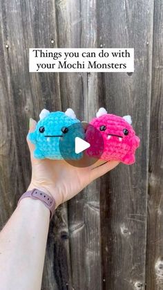 two small stuffed animals are held up in front of a wooden fence with the caption, things you can do with your mochi monsters