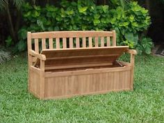 a wooden bench sitting on top of a lush green field