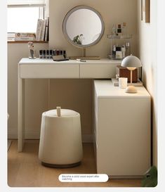 a white vanity with a round mirror on the wall above it and a stool next to it