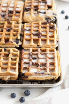 blueberry waffles with icing on a cooling rack