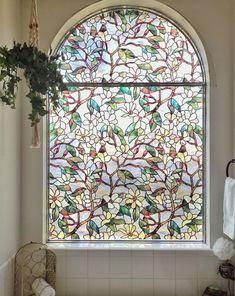 a bath room with a large window next to a sink