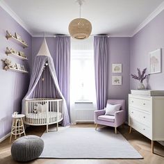 a baby's room with purple walls and curtains