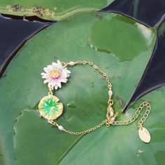 Instill your look with an exquisite touch of nature with our Lotus Dragonfly Bracelet. Crafted from brass enamel, this stunning piece is suitable for either festive occasions or everyday wear, making it an ideal gift. Its subtle yet impactful beauty will bring graceful elegance to any ensemble. DETAILS Plating: 18K Gold Materials:   18K Gold on Brass, Enamel Measurements:  Length: 6.10"(15.5cm) + Extender: 2.36"(6.0cm) Weight:  6.2g Charming Bracelet, Lotus Bracelet, Dragonfly Gifts, Dragonfly Bracelet, Lotus Jewelry, Gold Lotus, Dragonfly Jewelry, Unique Gift Wrapping, Detailed Necklace