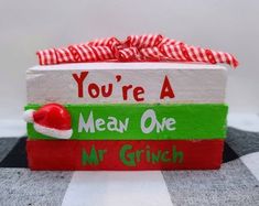 a wooden sign that says you're a mean one mr grinch on it