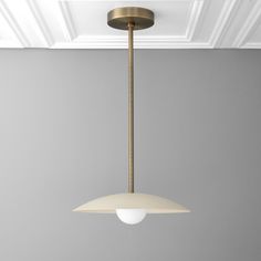 a light fixture hanging from the ceiling in a room with gray walls and white trim