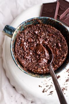 a chocolate cake in a bowl with a spoon