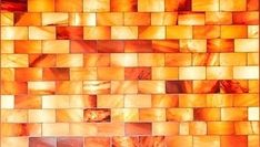 an orange and yellow tiled wall with squares