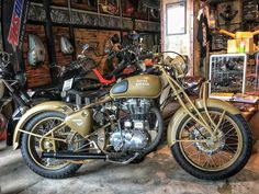 two motorcycles parked in a garage next to each other on the floor and some shelves