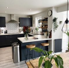 a kitchen filled with lots of counter top space next to a metal refrigerator freezer