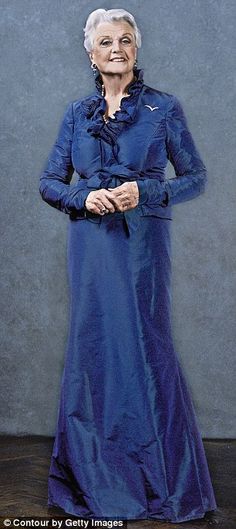 an older woman in a long blue dress