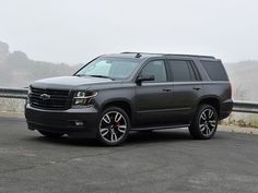 a black suv parked on the side of a road