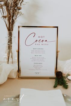 a menu sitting on top of a table next to a vase with flowers in it