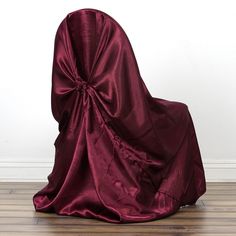 the back of a chair covered in a maroon cloth