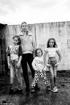 an old black and white photo of four children