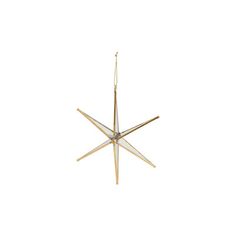 a gold star ornament hanging on a white wall