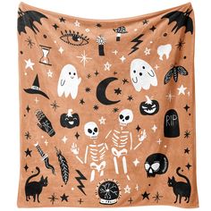 an orange halloween blanket with black and white skulls, ghostes, and stars on it