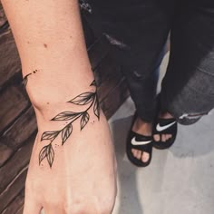 a woman's hand with a small tattoo on it