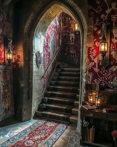 an archway leading to a hallway with red walls and rugs on the floor in front of it