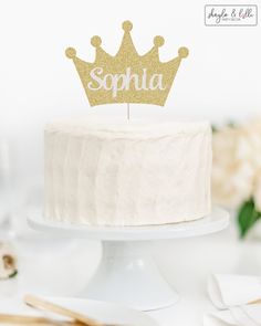 a white cake topped with a gold crown