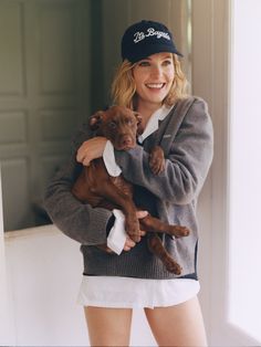 a woman holding a dog in her arms