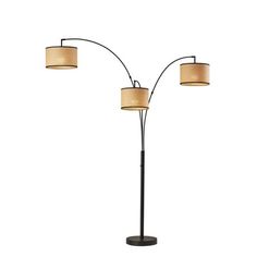 three light floor lamp with two lamps on each side and a beige shade over the top