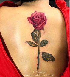 a rose tattoo on the back of a woman