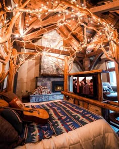 a bedroom with wooden beams and lights on the ceiling, along with a television set