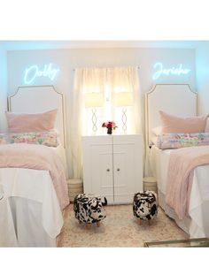 two twin beds in a bedroom with pink and white decor