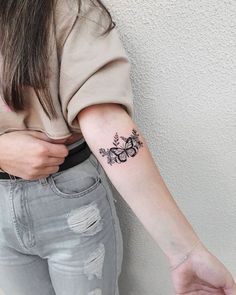 a woman with a small tattoo on her arm