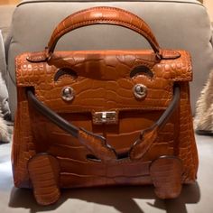 a brown handbag sitting on top of a couch