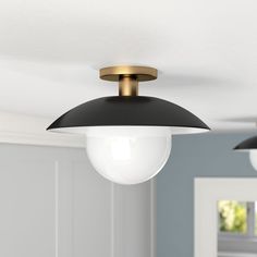 two lights hanging from the ceiling in a room