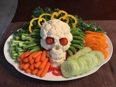 a white plate topped with vegetables and a skull