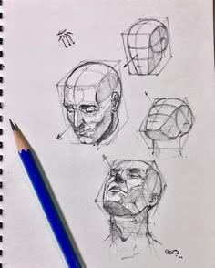 three different angles of the head are drawn on paper with a blue pencil next to it