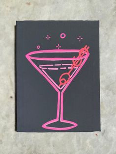 a drawing of a martini glass with pink and black outline on a gray paper background