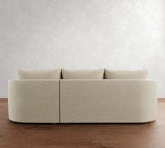 a white couch sitting on top of a wooden floor