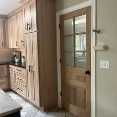 a kitchen with wooden cabinets and black counter tops