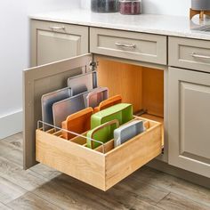 an open drawer in the middle of a kitchen