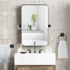 a bathroom sink sitting under a large mirror