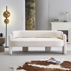 a white couch sitting on top of a rug in a living room