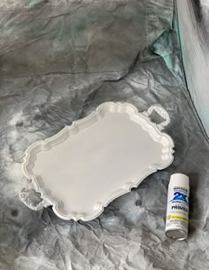 a white tray with some paint next to it