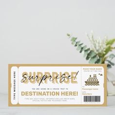 a ticket for surprise is sitting next to a vase with flowers