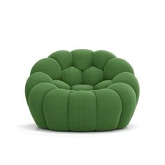 a green chair that is sitting on the white floor and it's made out of fabric