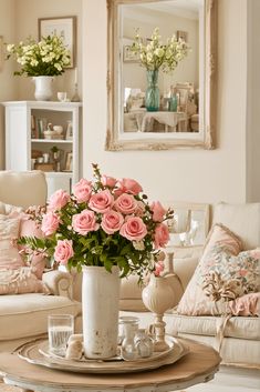 a living room filled with lots of furniture and flowers in a vase on top of a table