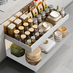 an open drawer in a kitchen filled with dishes