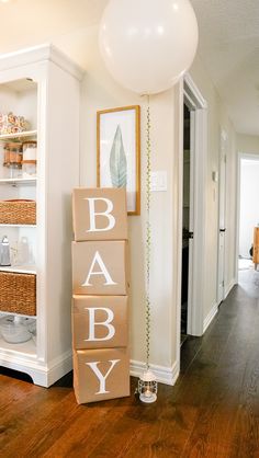 a baby sign and balloon in the hallway