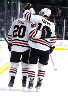 two hockey players congratulate each other on the ice