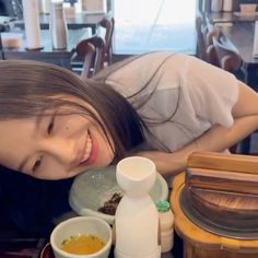 a woman laying on the ground next to some food