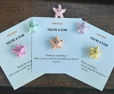 three little stars are on top of each other in front of a card that says you're a star